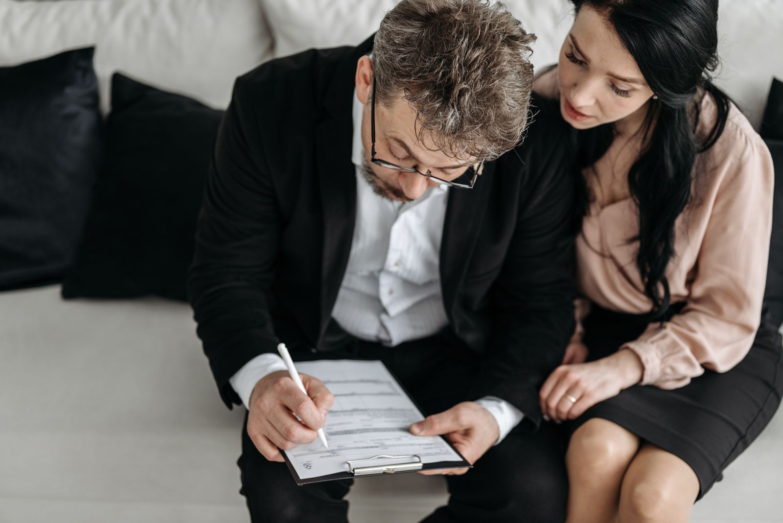 A couple filling out an application form together at home
