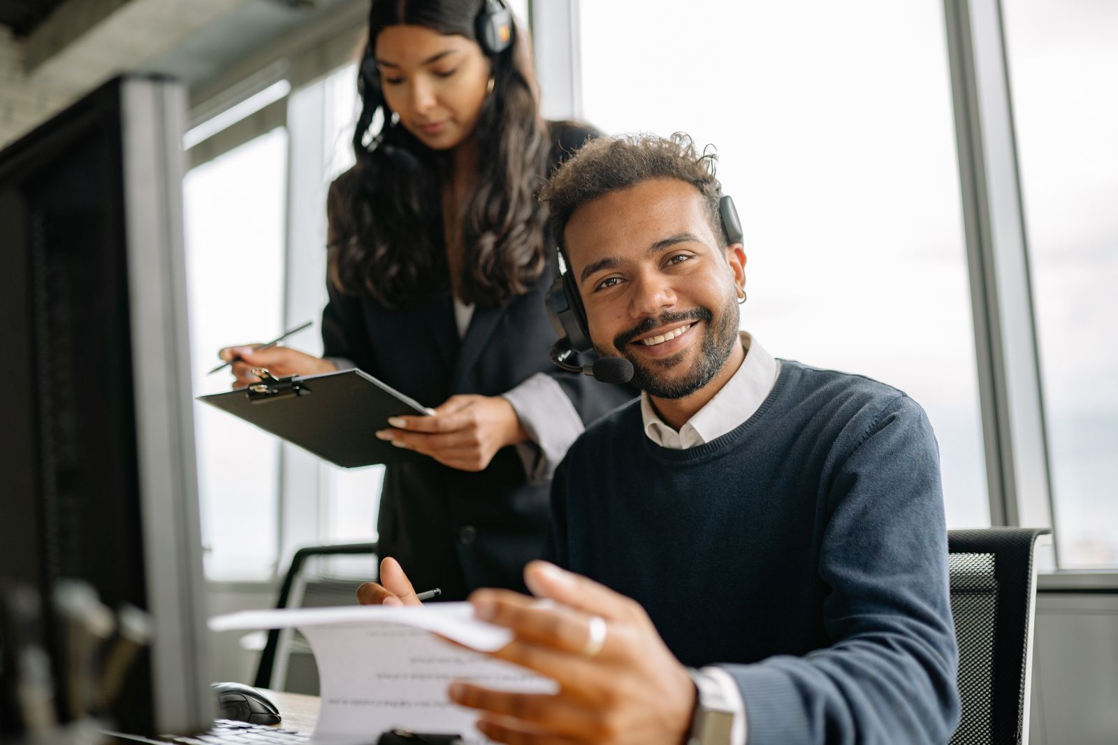 Call center agent with headset assisting a caller