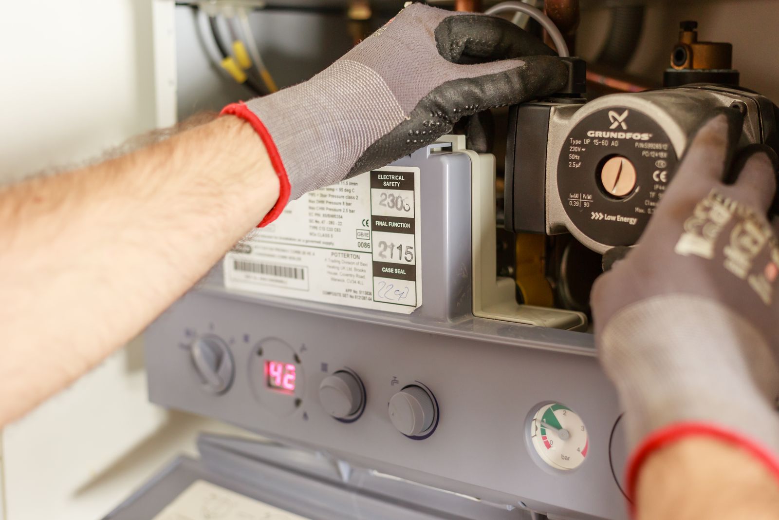 Technician servicing a home heating boiler